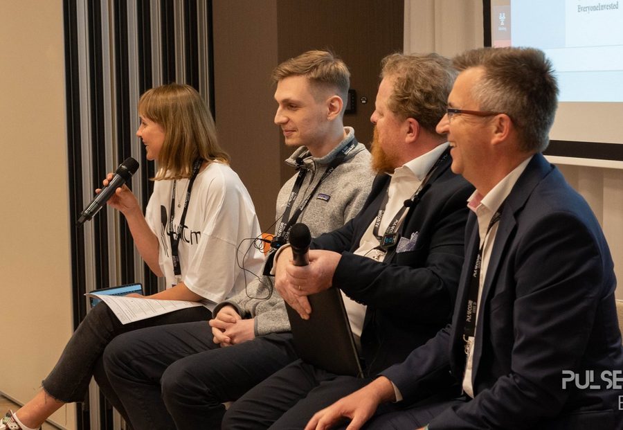 Four panellists seated with microphones during a discussion at a previous Excellence in Digital Banking summit